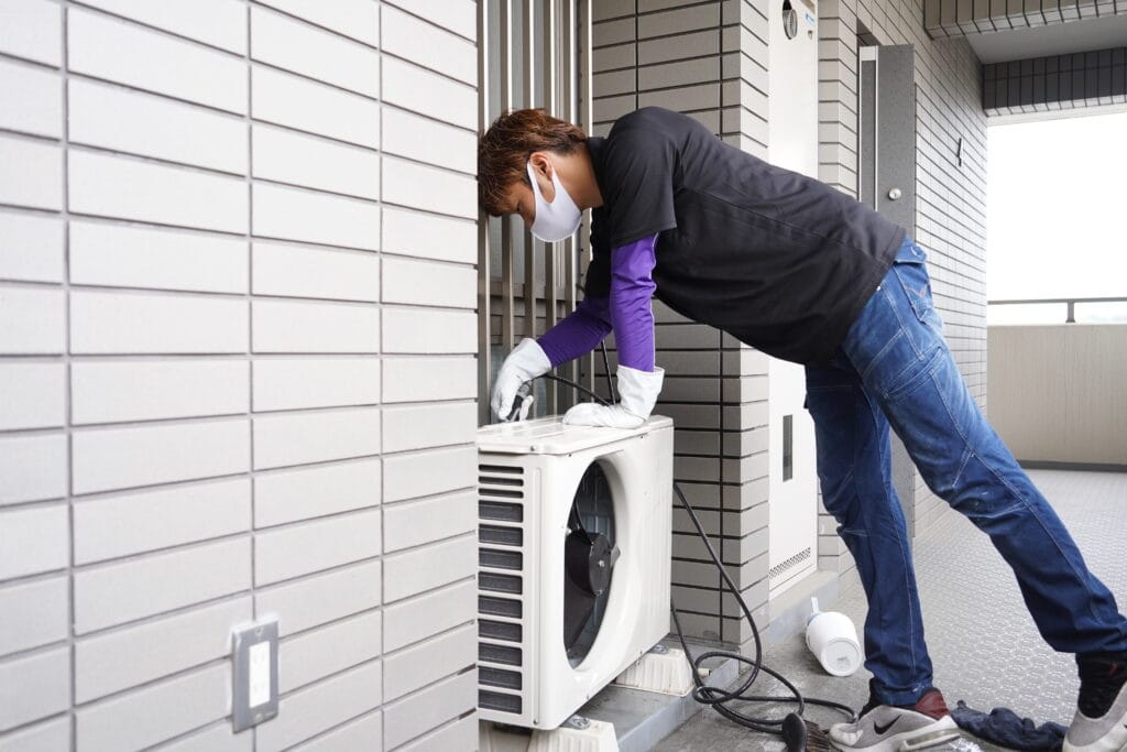 ココナラミーツでのエアコンクリーニング、高圧洗浄機で室外機を洗浄する様子